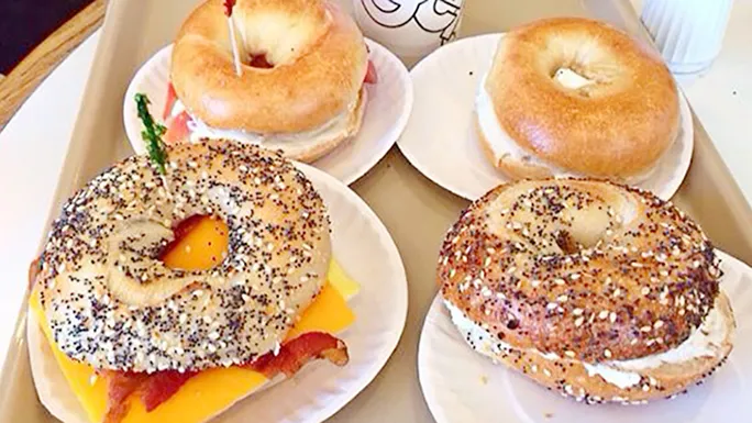 Exterior view of Bodo's Bagels with customers dining