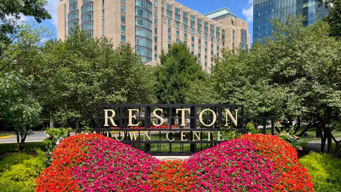 Pedestrians walking through the open-air shops and restaurants at Reston Town Center